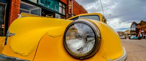 A photo of the front headlights of a vintage car.