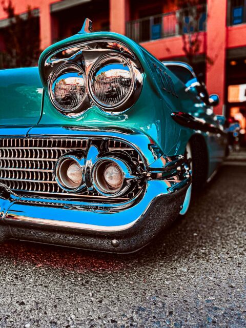 A vintage front end of a car at a car show.